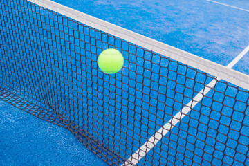 a paddle tennis ball in the air over the net, concept of racket sport background