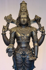 Fototapeta premium A Fine art Sculpture of Lord Venkateshwara or Balaji, in detail, carved in black stone, worshipped in Tirupati pilgrimage, Andra Pradesh, India.