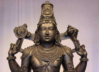 Fototapeta premium A Fine art Sculpture of Lord Venkateshwara or Balaji, in detail, carved in black stone, worshipped in Tirupati pilgrimage, Andra Pradesh, India.