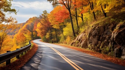 Obraz premium Scenic autumnal drive through a picturesque countryside landscape of rolling hills adorned with vibrant fall foliage