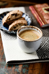 Cup of coffee and Cantuccini (Italian cookie) on dark wooden background. Copy space.