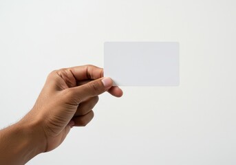 Obraz premium A human hand gently holding a blank white card, symbolizing simplicity and versatility, isolated on a white background