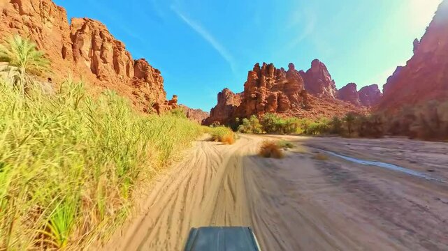 POV hyperlapse of a tourist driving a 4x4 vehicle on a sunny day in Wadi Al Disah, a mountainous area in the southwest of tabuk province, Saudi Arabia, exploring the natural beauty of the valley