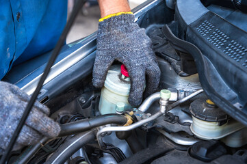 Close up local car mechanic fixing car in auto repair service shop
