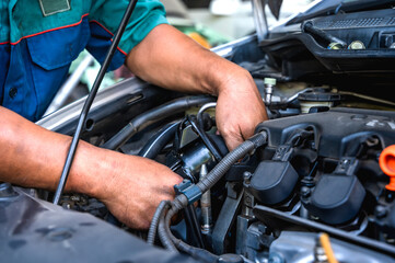 Close up local car mechanic fixing car in auto repair service shop