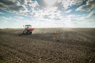 Tractor spreading artificial fertilizers