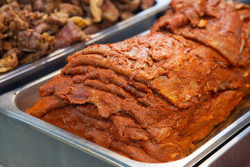 Cecina from Oaxaca. Mexican sliced cured pork or beef meat from Oaxaca displayed in a butcher shop in a mexican food market.