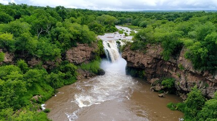 Obraz premium Aerial View of Lush Waterfall
