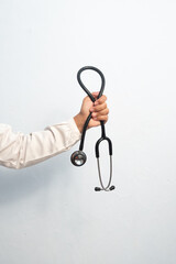 Female doctor hand holding stethoscope isolated white background. Medical and hospital equipment concept.