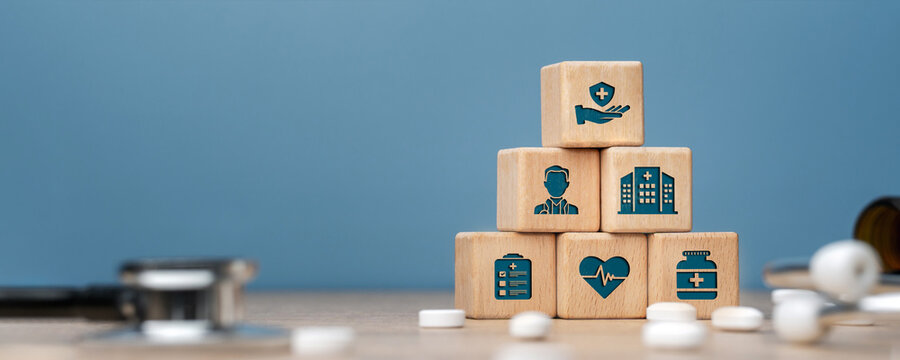 Health care and Health insurance concept. Benefits of health insurance, medical expenses, providing financial security. hand arranging wood block, health insurance icon  on wood block.