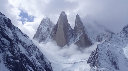Majestic Snowy Peaks Enveloped in Mist Dramatic Mountain Landscape