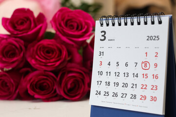 red rose lay on the calendar with the date of 8 march. Concept: International Women's Day