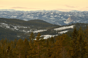 Majestic Sunset View from Norefjell Mountain: A Winter Evening Above the Clouds Over the Valley and Lake Krøderen in Norway