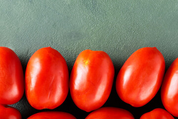 Homegrown Red Tomatoes on Textured Green Surface for Sustainable Farm-to-Table Meals, Top View, Copy Space