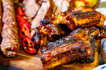 Delicious barbecue ribs served on a wooden platter at a summer gathering