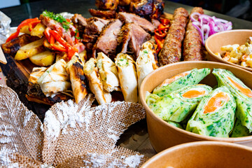 Delicious assortment of grilled meats and fresh vegetables on a platter