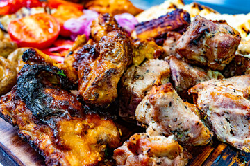 Grilled meat platter with vegetables at outdoor summer gathering