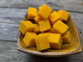 diced cheese lies in a wooden plate
