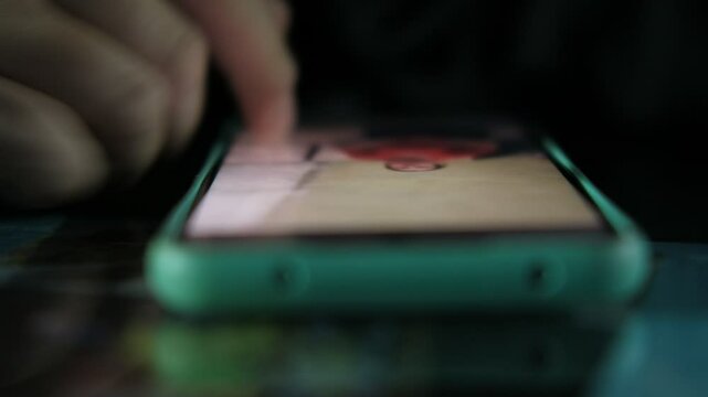 Close-up fingers in mobile phone