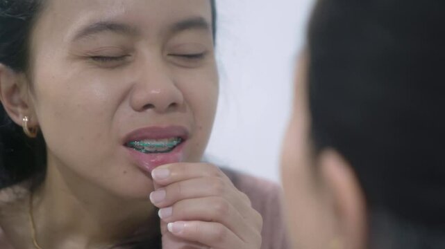 asian Indonesian woman having canker sore on her lips