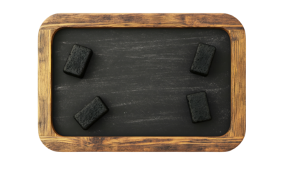 Charcoal briquettes on rustic chalkboard background