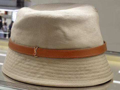Cassandre bucket hat in beige organic cotton with brown leather band with YSL logo by Yves Saint Laurent. Milan - Italy,11 January 2025