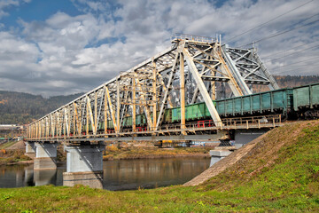 Train traffic. Railway bridge and trains with wagons