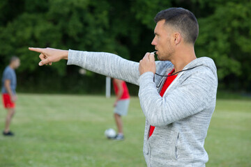 referee with whistle at soccer game