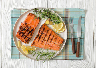grilled salmon fish fillet with herbs, top view
