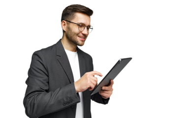 Young man in business attire smiling while using a tablet in a professional setting