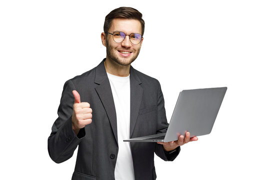 Young man gives thumbs up while holding laptop, showing success in digital work environment