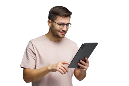 Young man engaged with tablet technology while smiling and enjoying a moment of connection