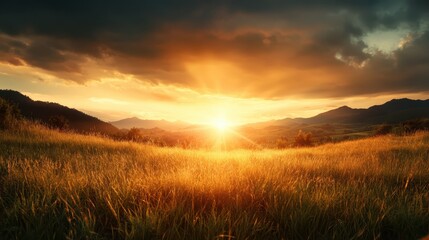 Fototapeta premium A stunning sunset paints the sky over rolling mountains, casting golden rays on a lush field, capturing the beauty and tranquility of nature in a serene landscape.