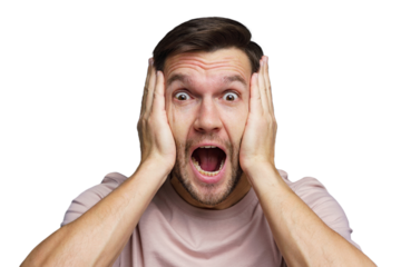 Man expresses surprise and shock with hands on his face, looking directly at the camera in bright setting