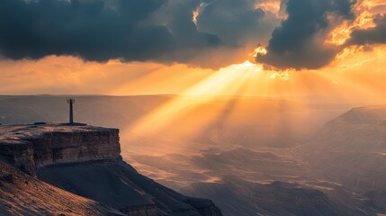 A sunbeam cutting through the clouds over a vast desert landscape.