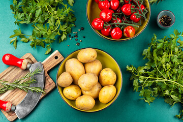 Fresh raw potatoes and bunch of wet ripe tomatoes.