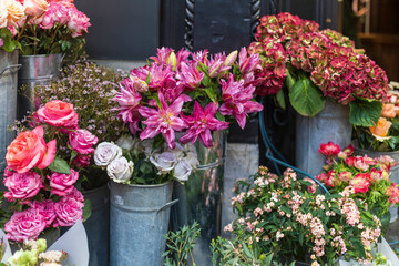Naklejka premium Burgundy lilies and a bouquet of hydrangeas, red anemones, buttercups, and orange roses with eucalyptus branches for interior decoration on weddings, dates, and funerals.