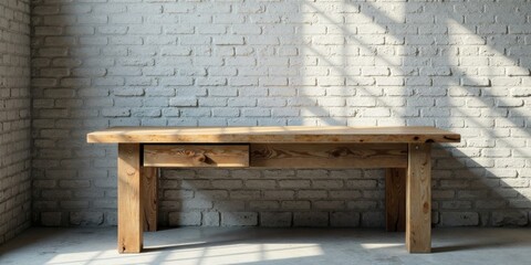 Rustic wooden table with single drawer against a whitewashed brick wall, bathed in sunlight
