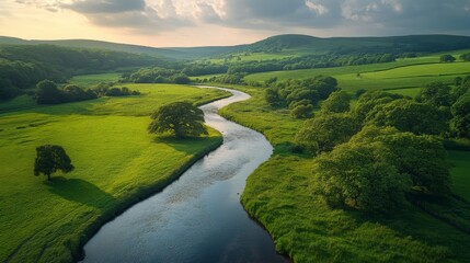 Fototapeta premium Scenic River Valley Landscape with Rolling Hills and Lush Green Fields in a Tranquil Setting