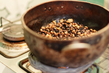 Home made roasted coffee beans in a rural kitchen. Tierradentro, Cauca, Colombia.