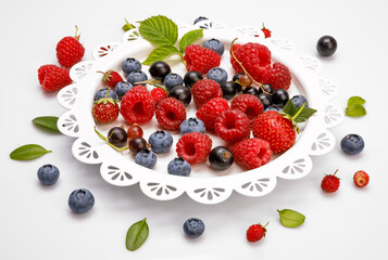 Set fresh berry. Mix summery fruit raspberry strawberry currant blueberry and wild with green leaf still life