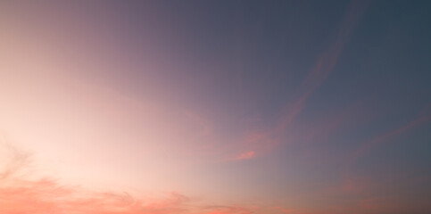 Red evening sky panorama with soft clouds. Summer sky background