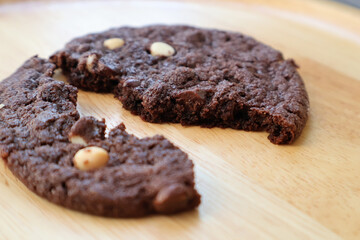 Side view Broken soft Chocolate Cookie with chocolate chips on wooden board