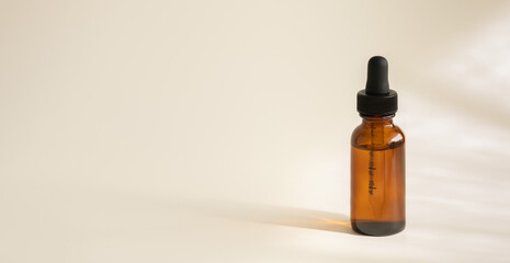 Dark amber glass bottle, cosmetic product without inscription and without label. Selective focus