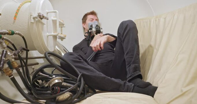 Man in hyperbaric chamber using BIBS mask