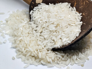 Unprocessed rice, on a natural blurred white background.