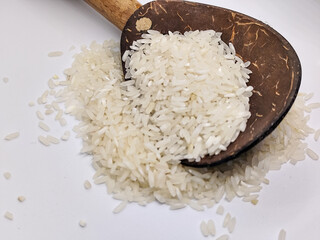 Unprocessed rice, on a natural blurred white background.
