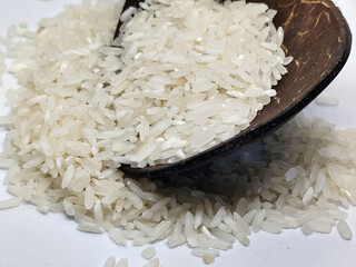 Unprocessed rice, on a natural blurred white background.
