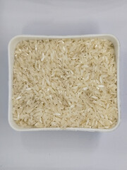 Unprocessed rice, on a natural blurred white background.