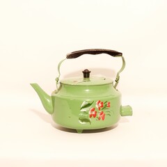 This Vintage Green Floral Teapot has a charming Black Handle, ideal for tea lovers and collectors